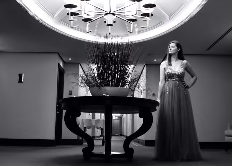 A woman wearing a private eveningwear gown in an elegant interior