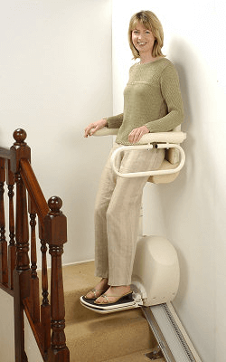 Image of a woman using a standing stairlift
