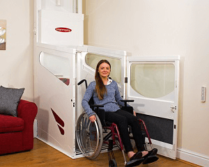 Image of a woman in a wheelchair leaving a vertical lift without a shaft