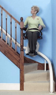 Image of a woman using a seated stairlift