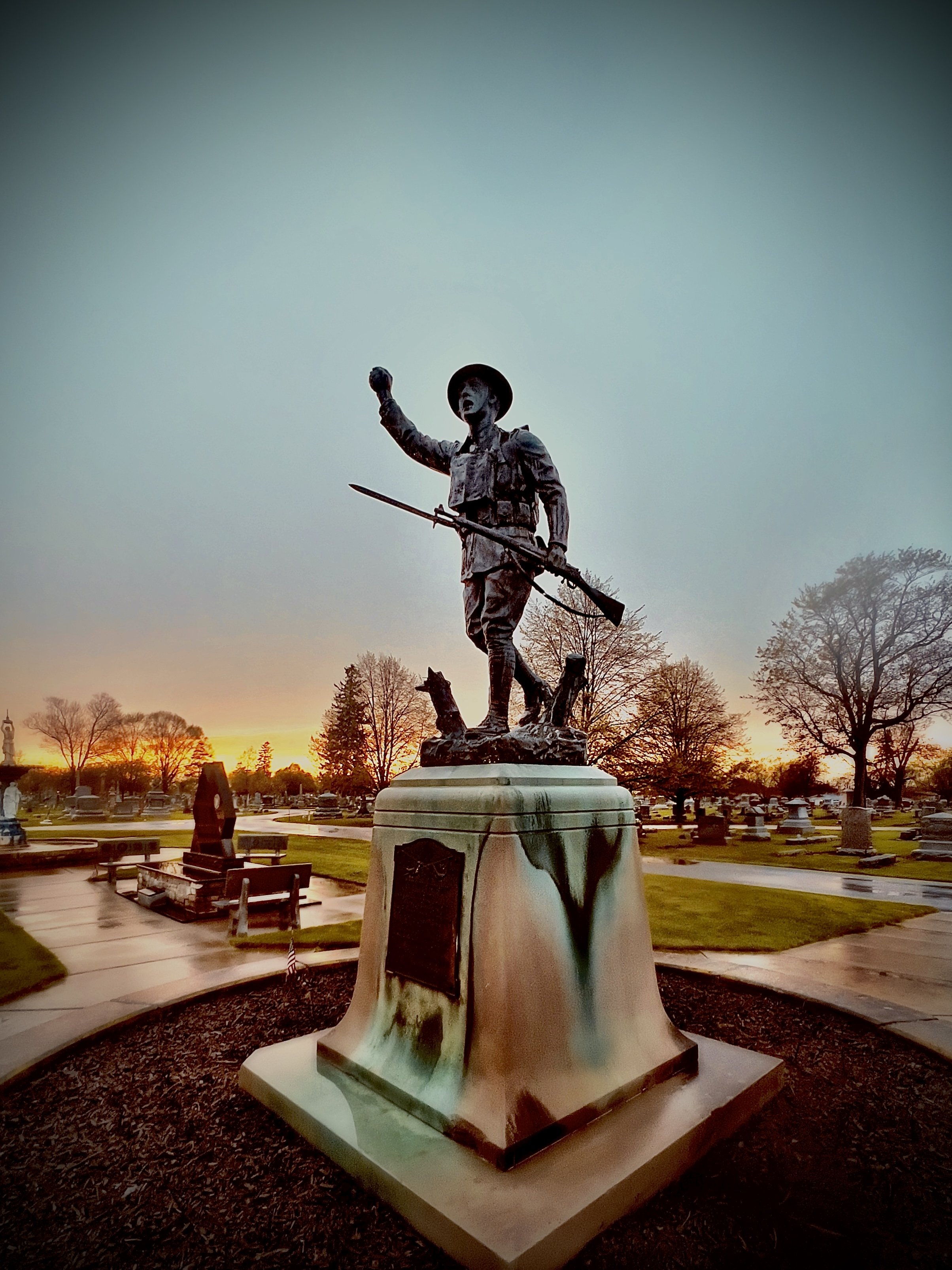 A Fostoria photographer captures the essence of American Doughboy statues, including those at Fountain Cemetery, against a backdrop of natural beauty.