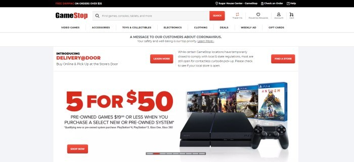 This screenshot of the home page for GameStop has a black header and a white search bar and navigation bar above a white main section with orange and black text announcing a sale on pre-owned games and at-door delivery on orders, as well as an image of five PS4 video games.