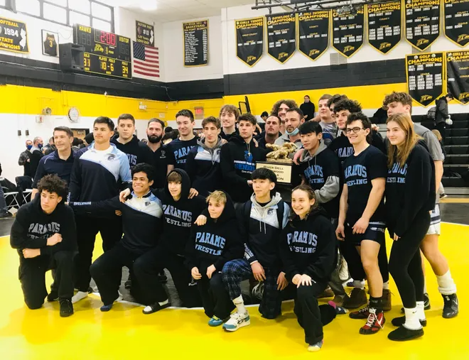 The Paramus wrestling team celebrates with the trophy after beating Passaic Tech in the River Dell/Westwood Duals championship. Jan. 15, 2021.