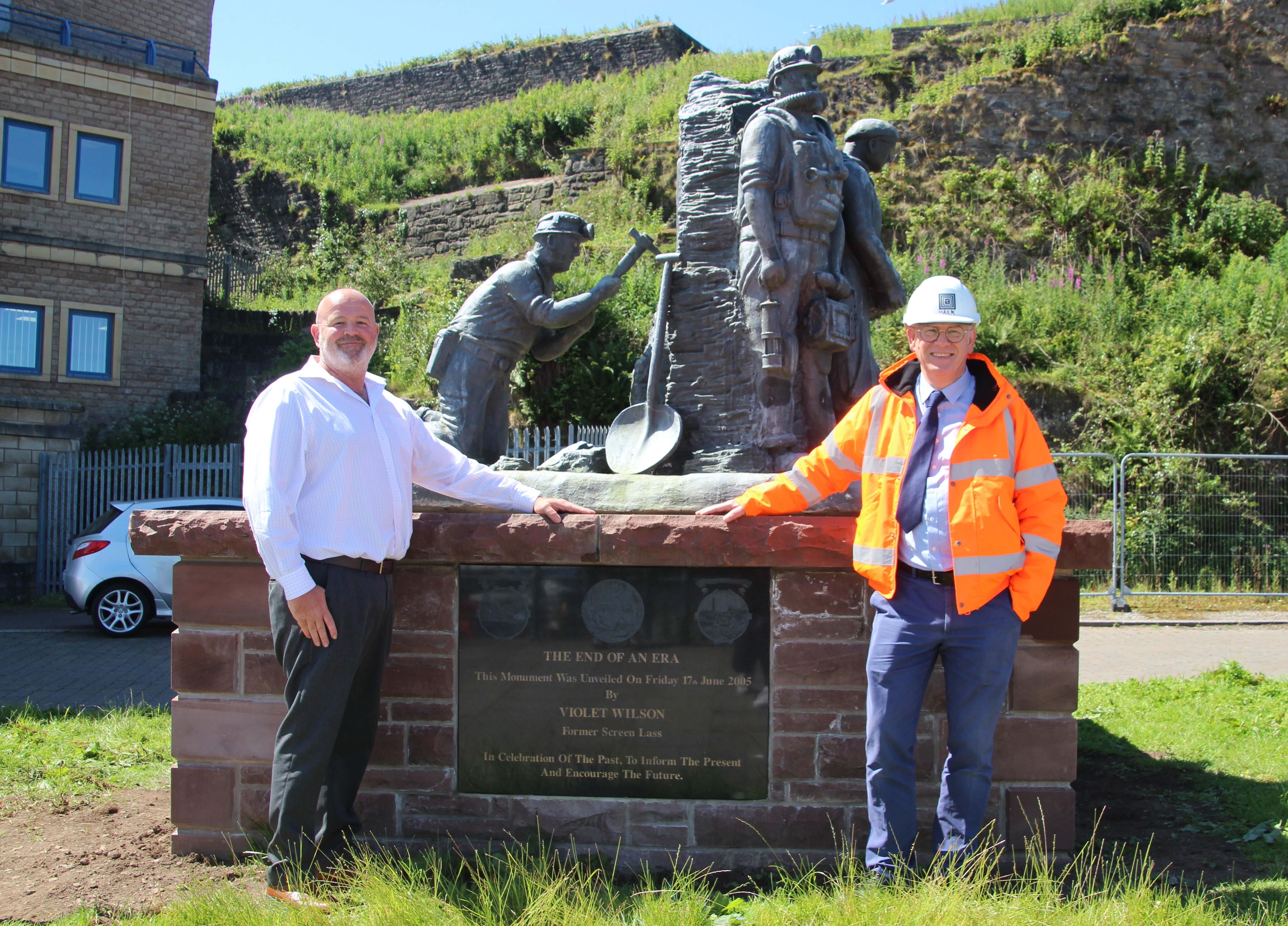 Lewis Stainton (Operations Manager, Whitehaven Harbour Commissioners) and Mark Paterson (Contracts Manager, Thomas Armstrong) alongside the monument in its new location