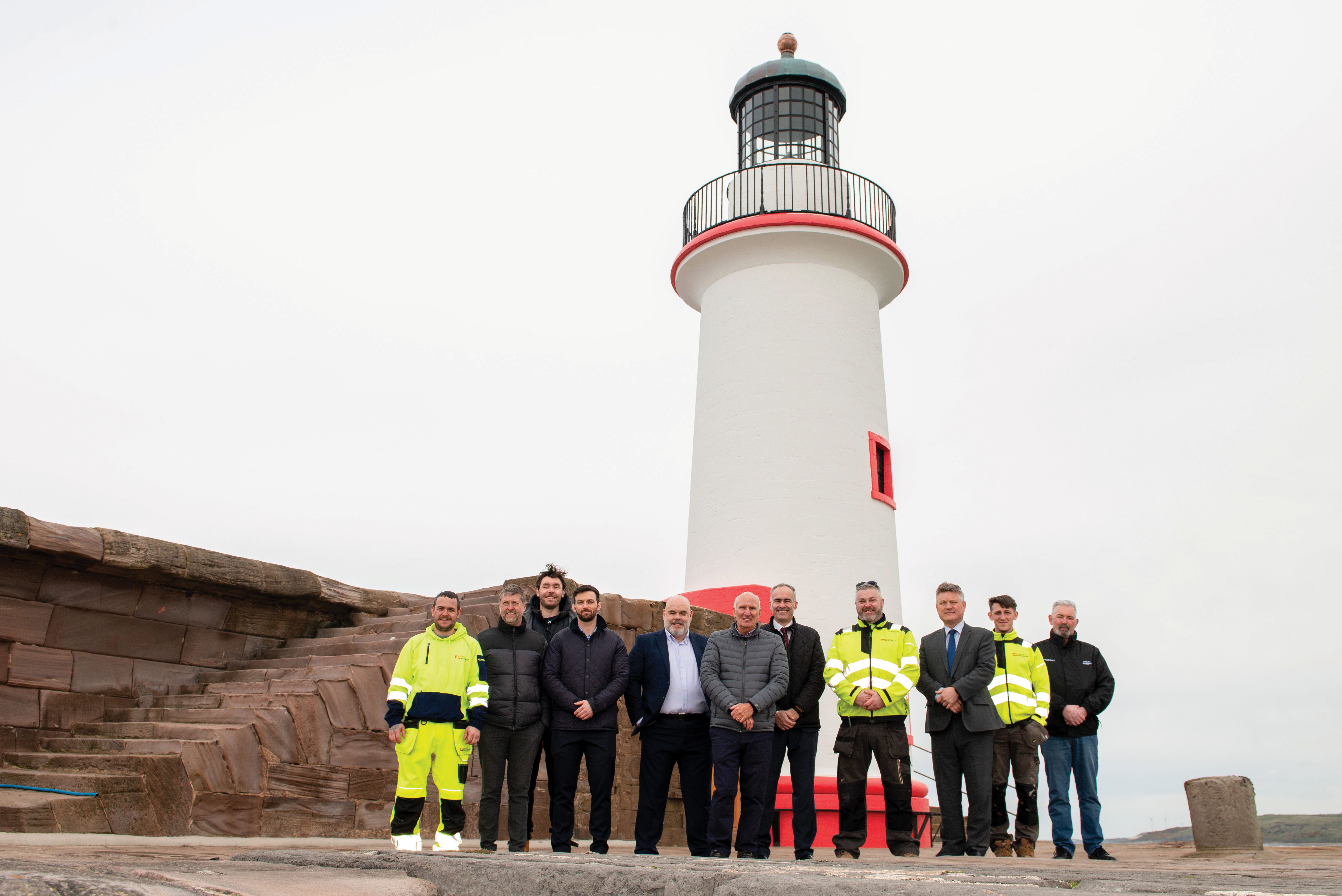 John Baker stands alongside the team responsible for the restoration of the West Pier Lighthouse including Trevor Prowse and CRS Facility Management
