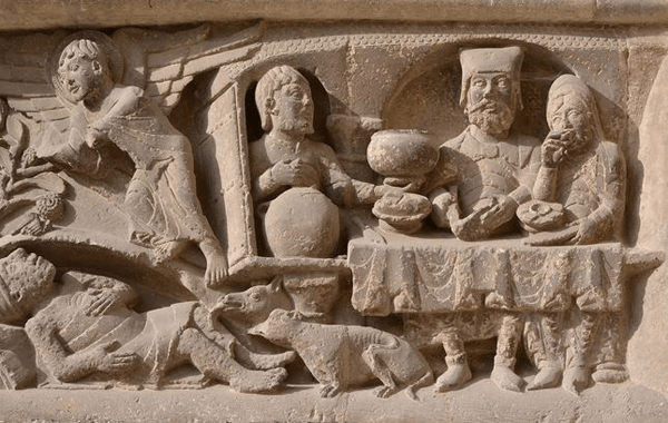 Lazare dont les pustules sont léchées par les chiens, portail de l’abbatiale de Moissac (vers 1120), Tarn-et-Garonne. La même scène est représentée dans un  vitrail de la cathédrale de Bourges (voir agrandissement).