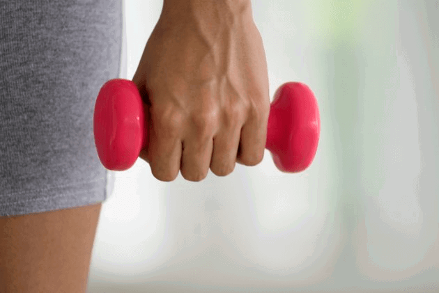 Young woman exercising with weights