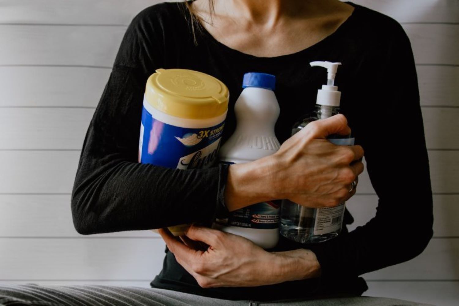 person holding cleaning products