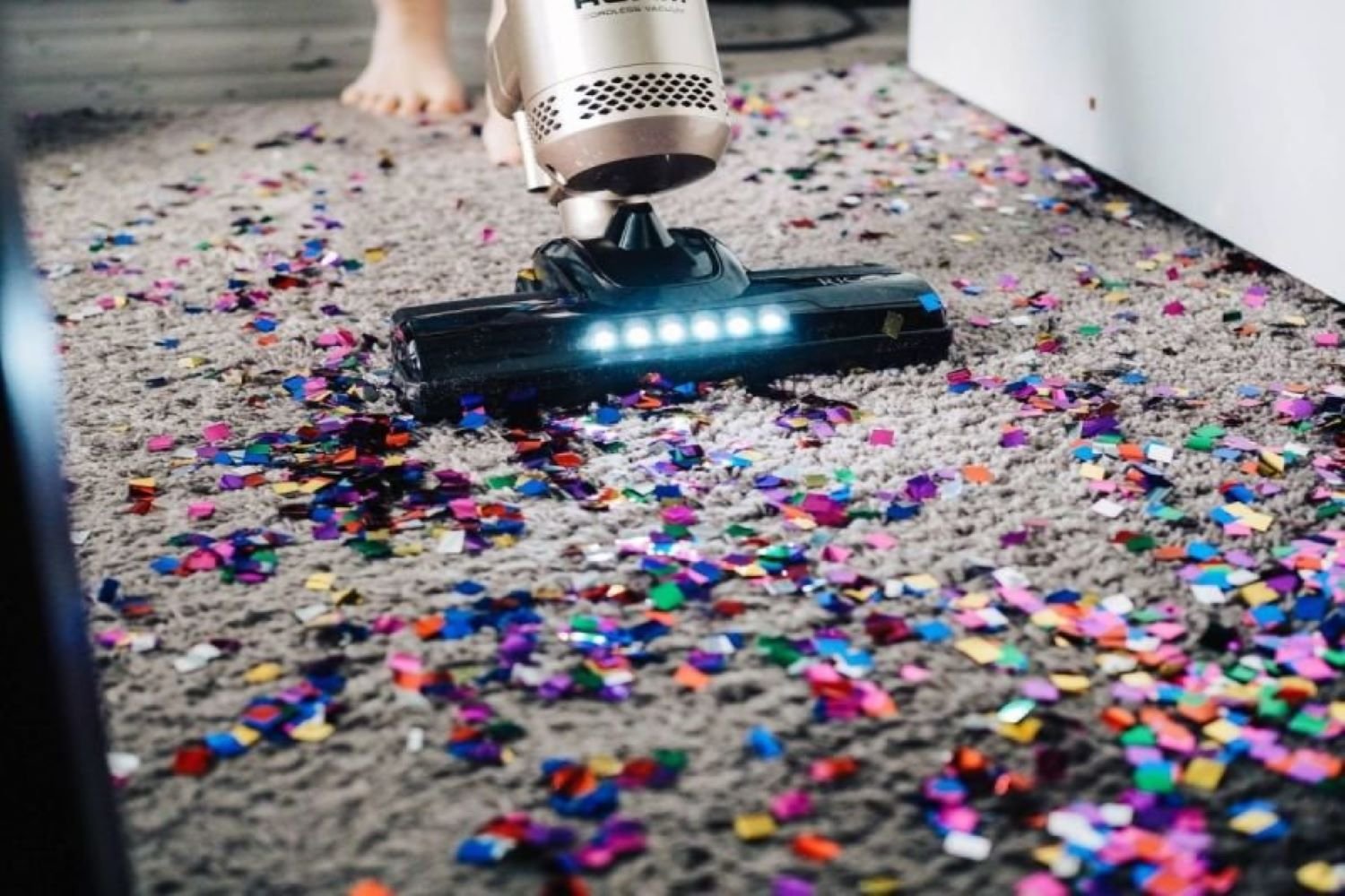 hoovering the floor covered in sparkles