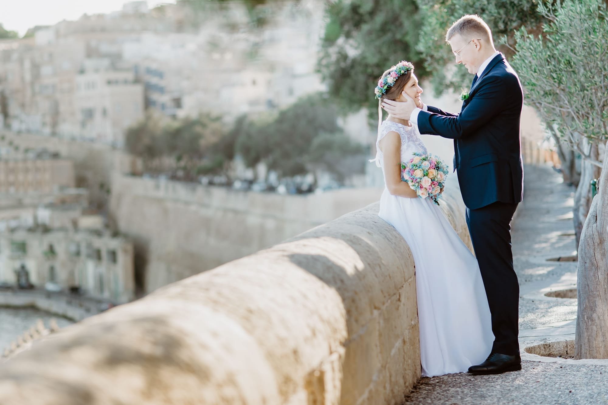 bride and groom in valletta with background view of the harbour