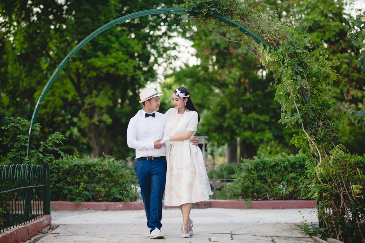 bride and groom walking during photo session at san anton gardens