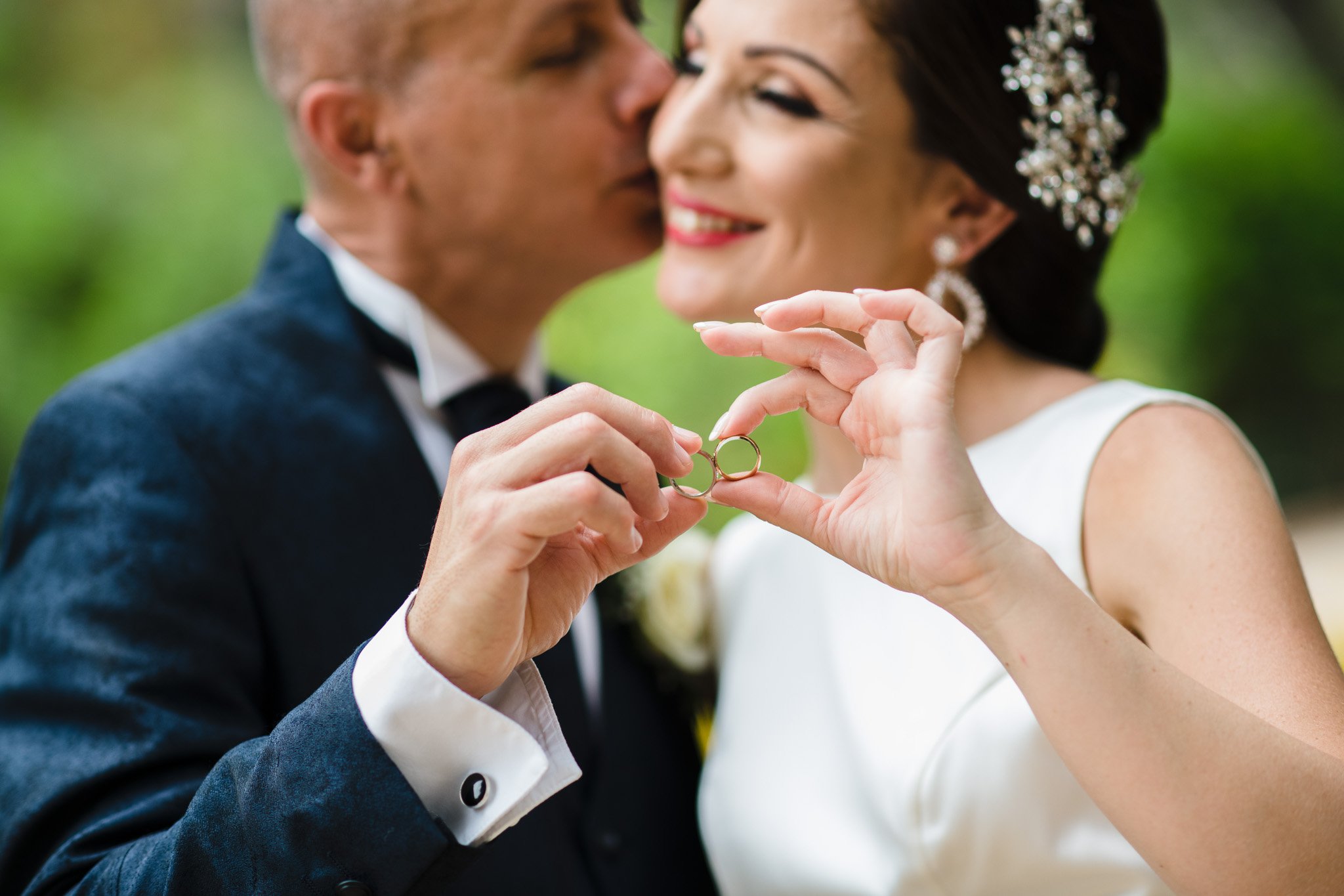 bride and groom showing wedding rings