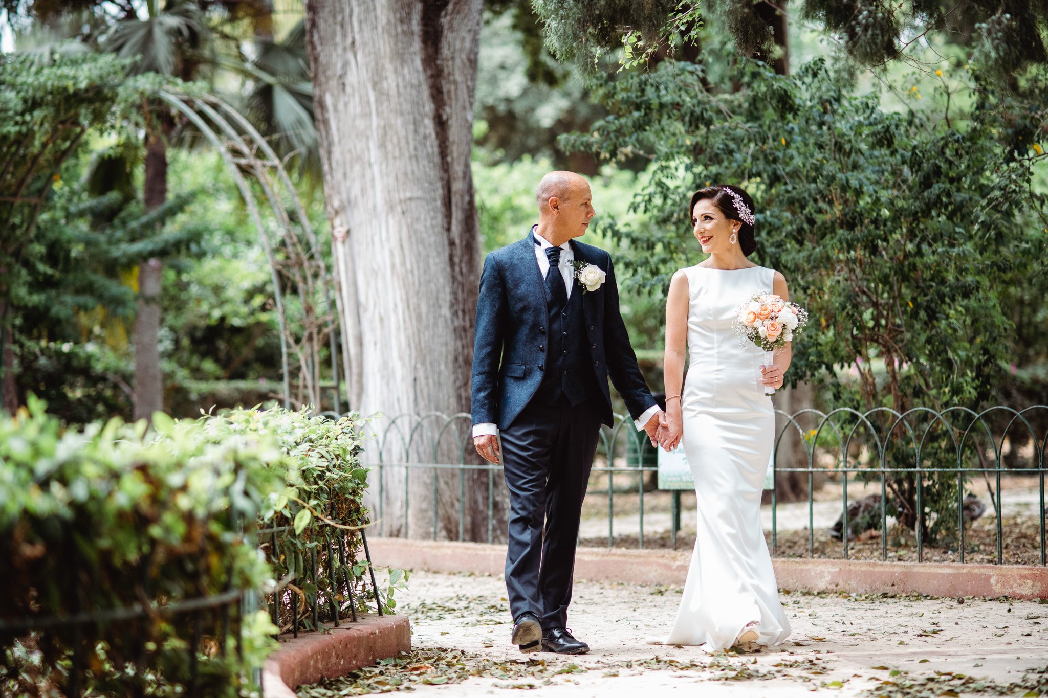 bride and groom walking at san anton gardens malta