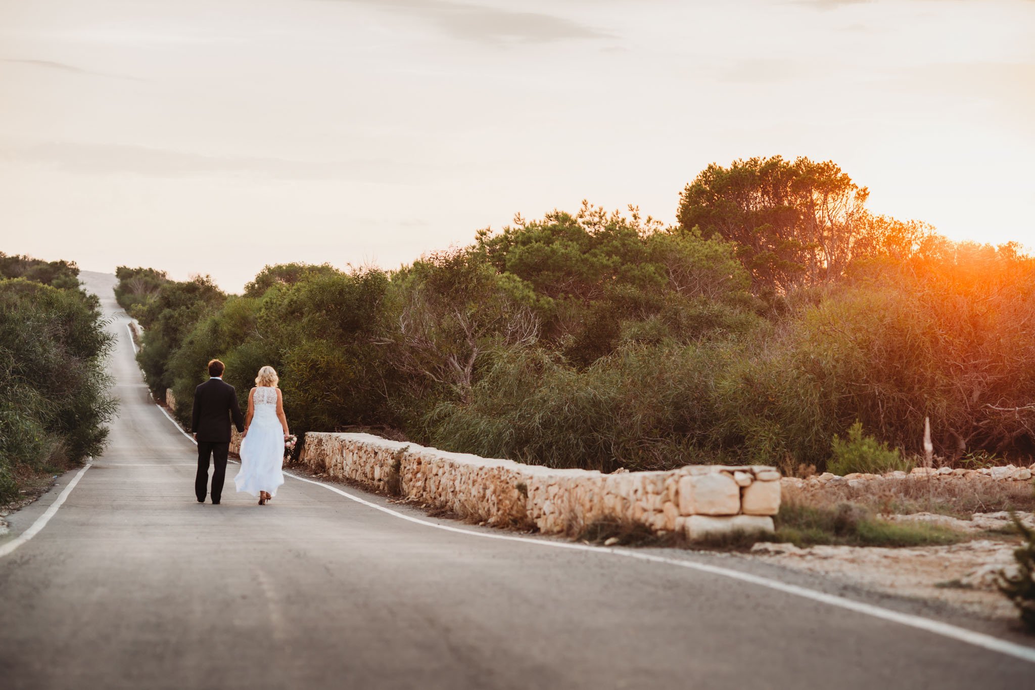 Bride and groom walking in a country lane in near Valetta in Malta