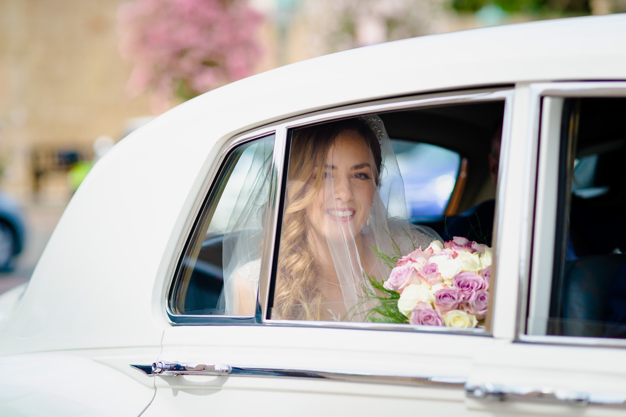 Bride arriving for a wedding, image taken through a car window