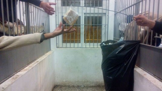 Refugees sharing their food in the detention center
