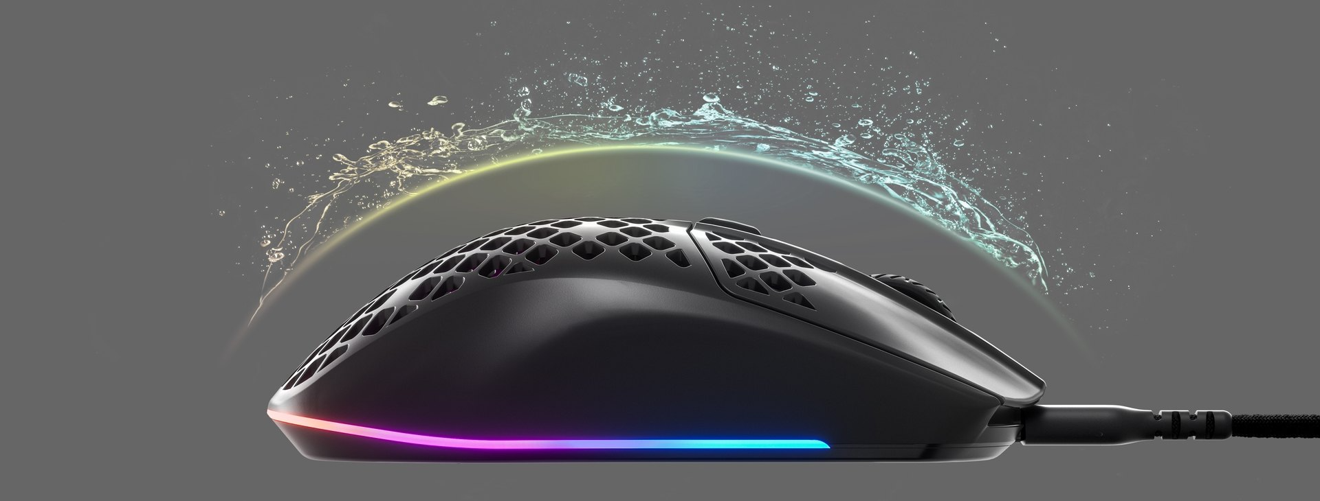 An Aerox 3 mouse with an invisible shield protecting it from incoming water splashing, to convey the waterproofing features