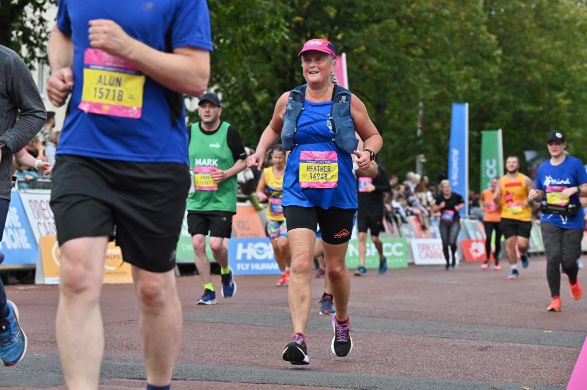 The author of the blog post smiling as she approaches the finish of the Cardiff Half marathon.