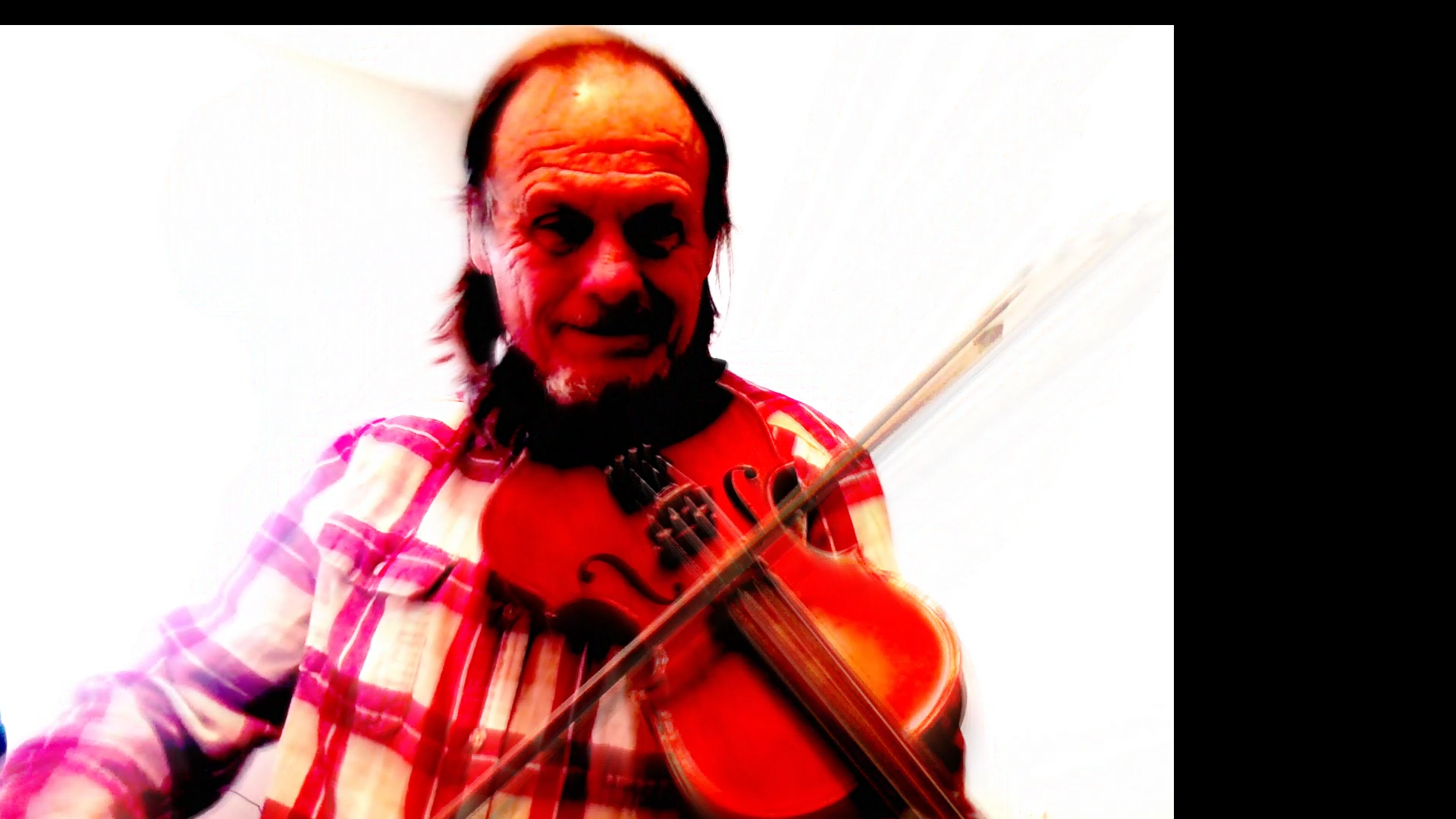 Rick McVicar playing a violin.