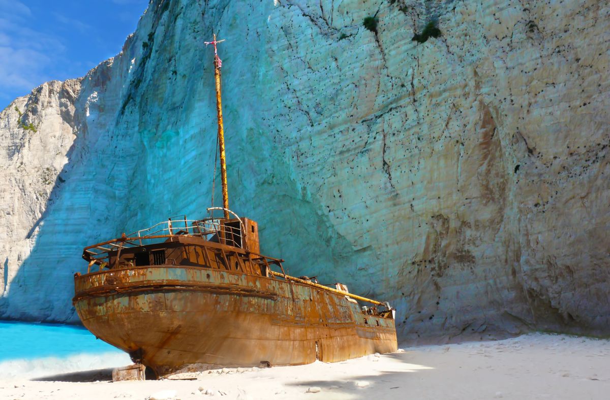 Navagio Beach, Greece: A Hidden Paradise on Zakynthos Island. Navagio Beach, located on the mesmerizing island of Zakynthos in Greece, is a secluded paradise that leaves visitors in awe. Enclosed within a cove and surrounded by dramatic cliffs, this beach boasts turquoise waters that contrast beautifully with the golden sand. Adding to its allure is the wreck of a smuggler's ship, which enhances the beach's mystique. Immerse yourself in the breathtaking beauty of Navagio Beach and create memories that will last a lifetime.