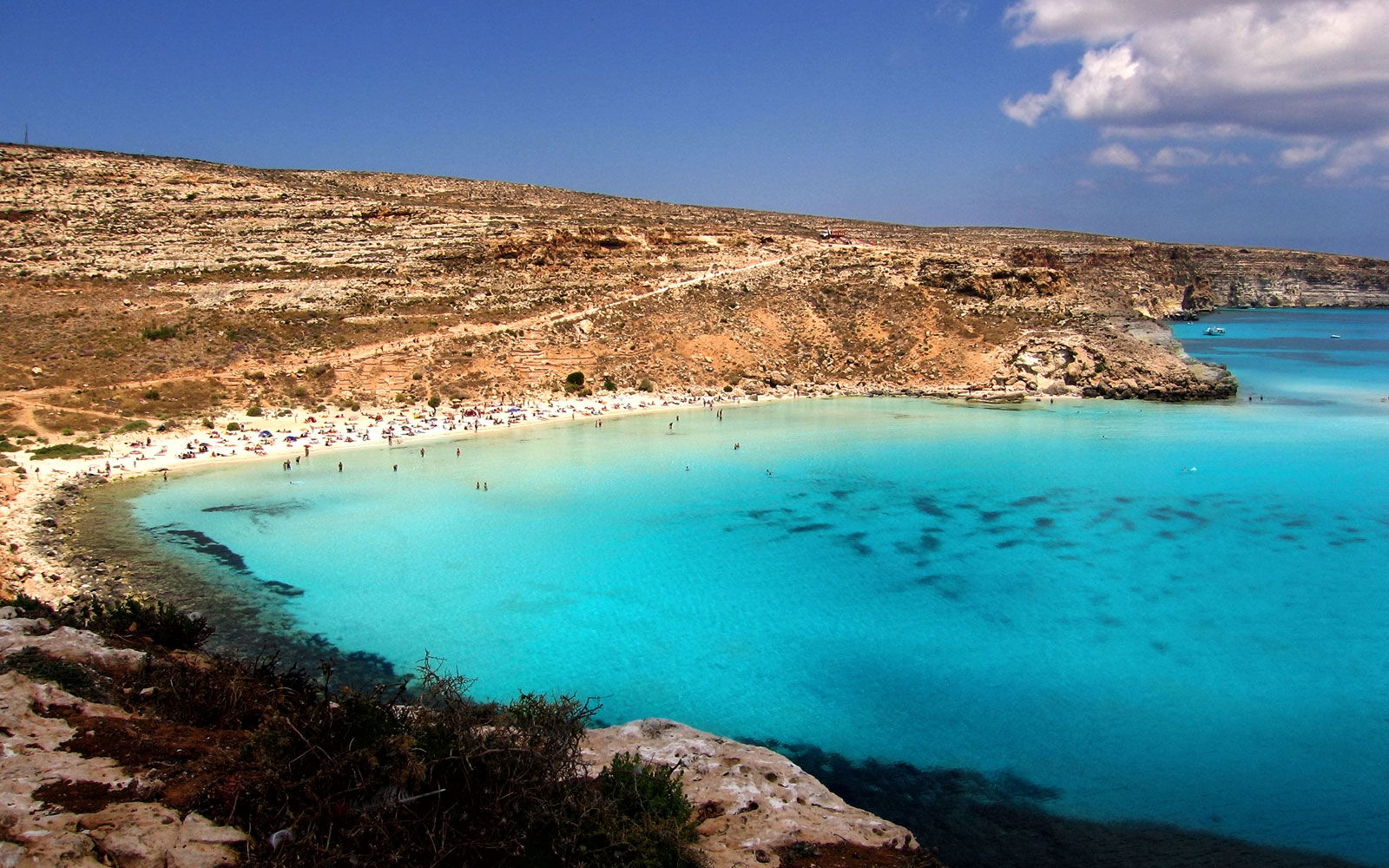 Rabbit Beach, Italy: A Secluded Paradise on Lampedusa Island. Discover the secluded paradise of Rabbit Beach on the charming island of Lampedusa in Italy. Known for its crystal-clear waters, fine golden sand, and secluded location, this beach is an idyllic retreat for nature lovers. Dive into the vibrant underwater world, bask in the warm Mediterranean sun, or simply enjoy the serenity of this hidden gem. Rabbit Beach is a true haven where you can escape the noise of everyday life and find tranquility.