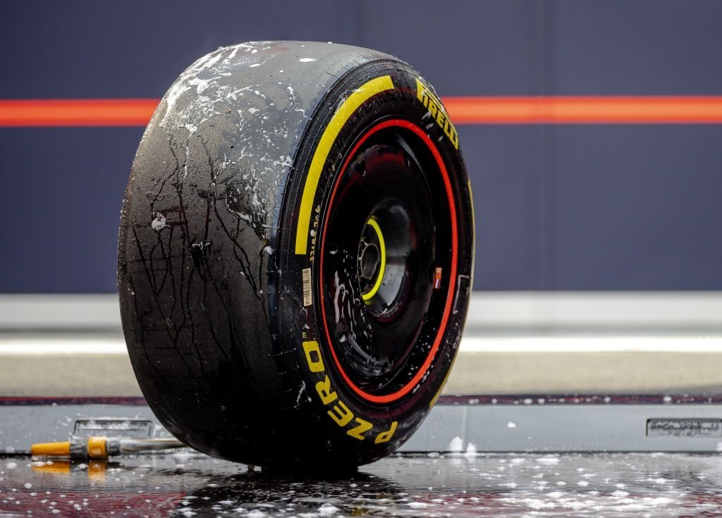 Formula One car tires, Red Bull Racing-mechanic-cleans-pirellis-new-18-inch Via Popular Mechanics.