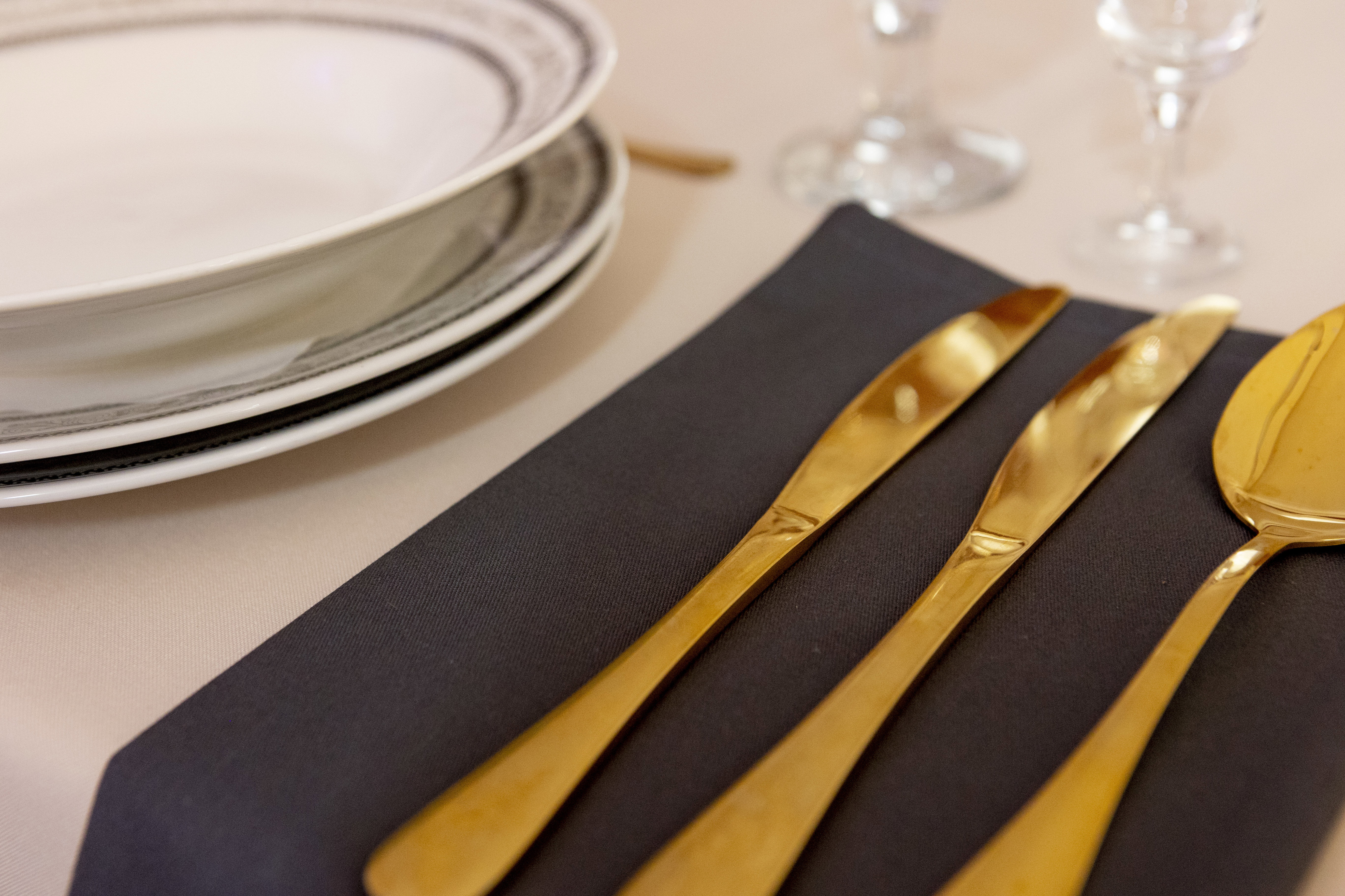 Gold cutlery and round plates.