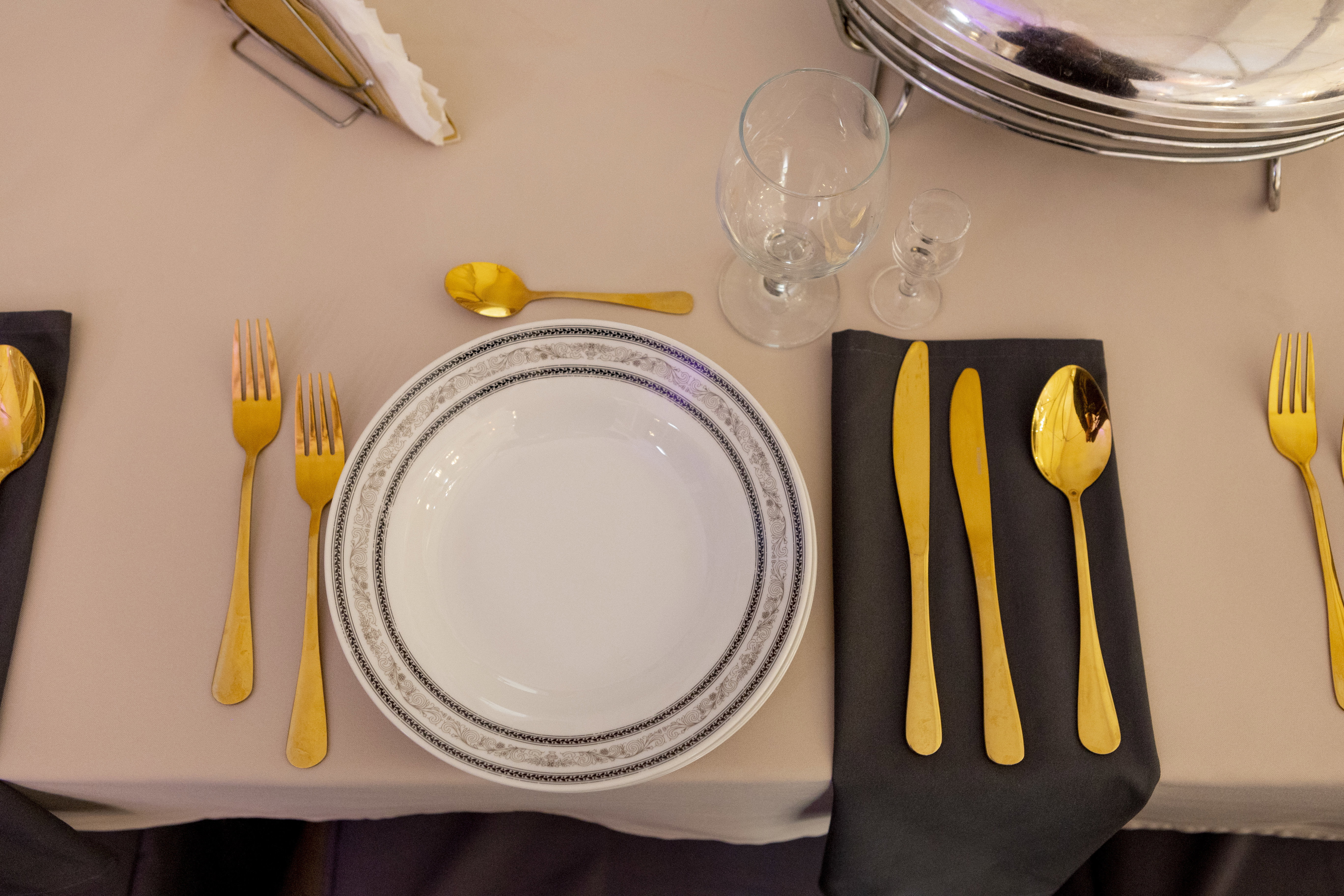 Gold cutlery and round plates.