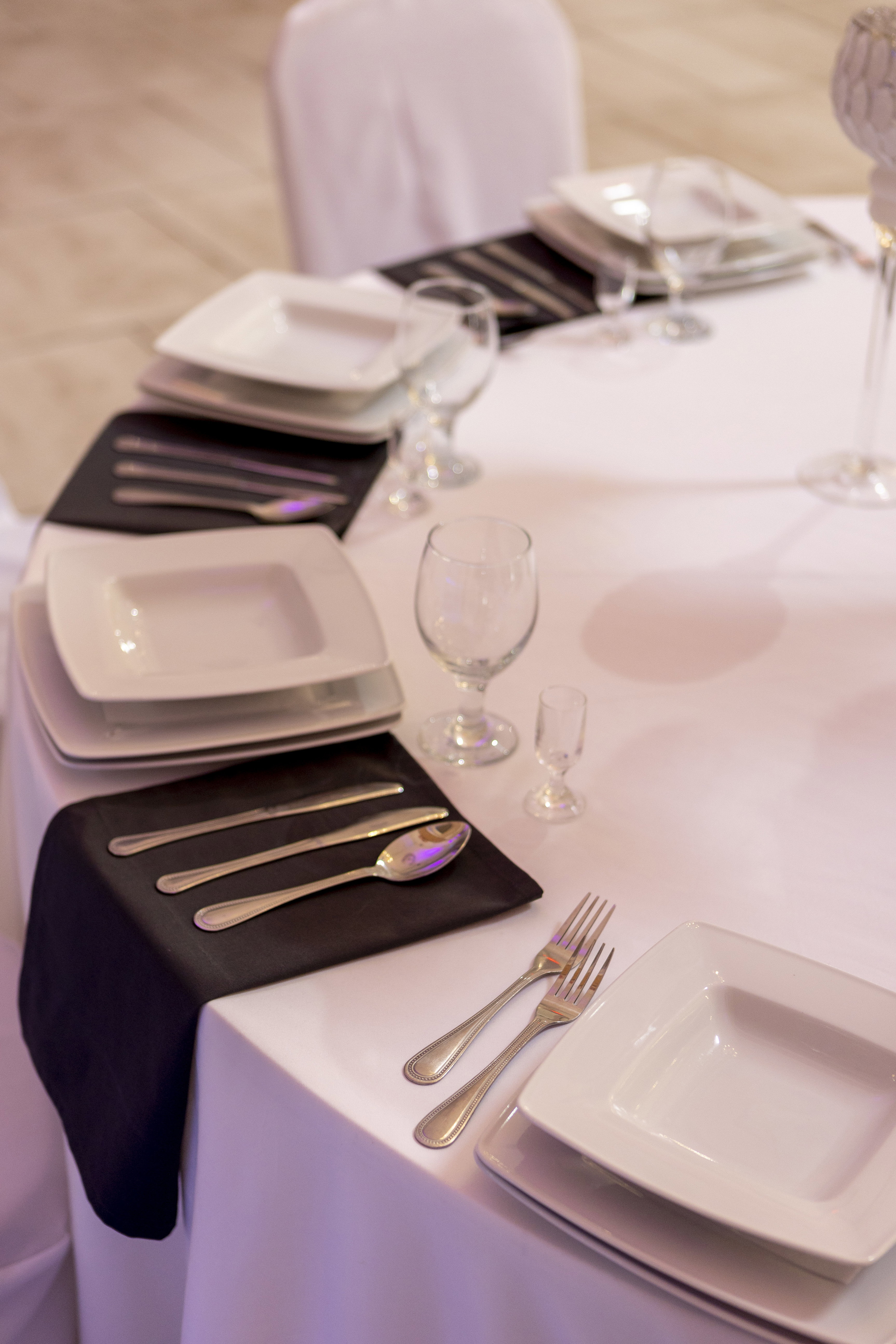Silver cutlery and square plates.