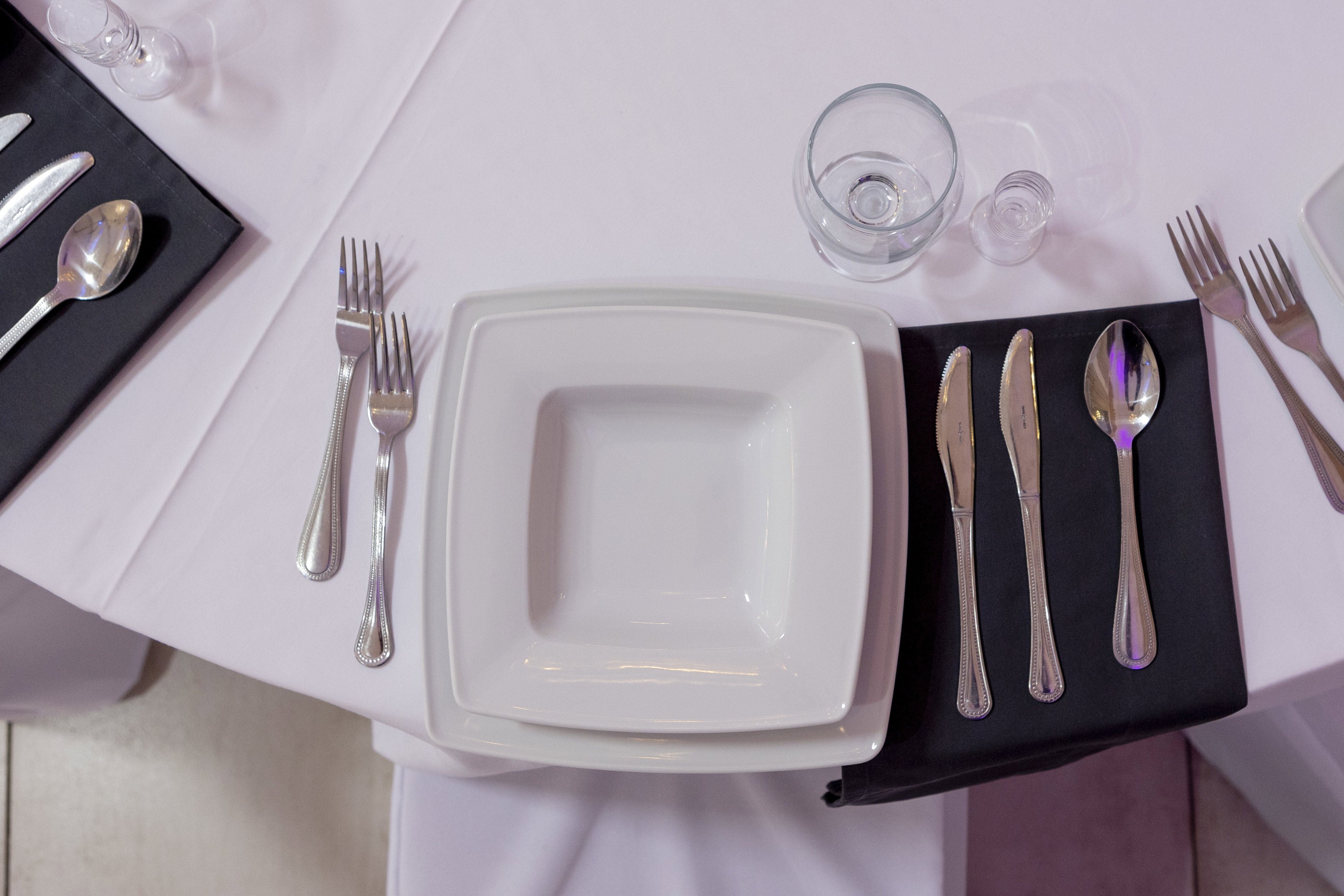 Silver cutlery and square plates.