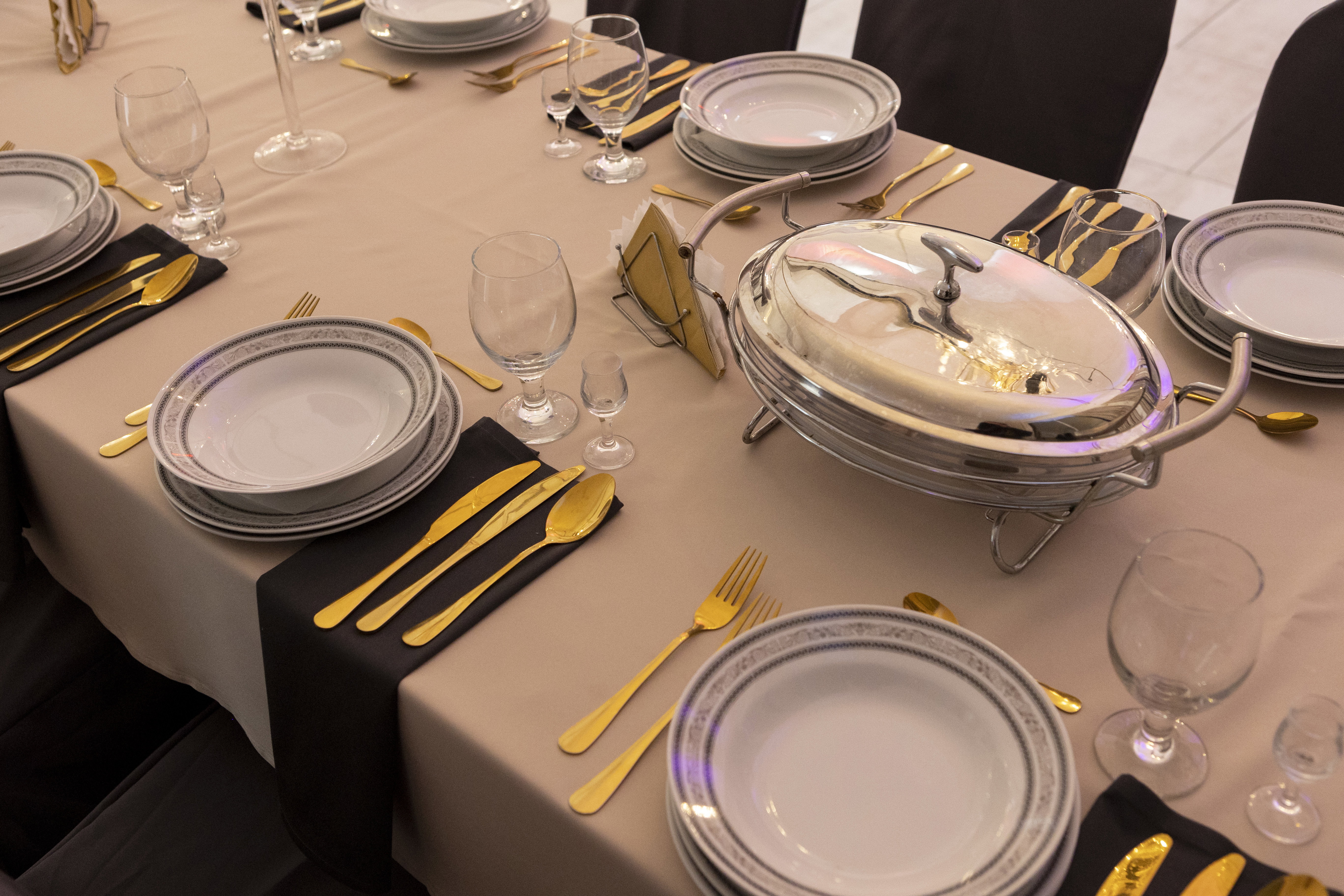 Gold cutlery and round plates.