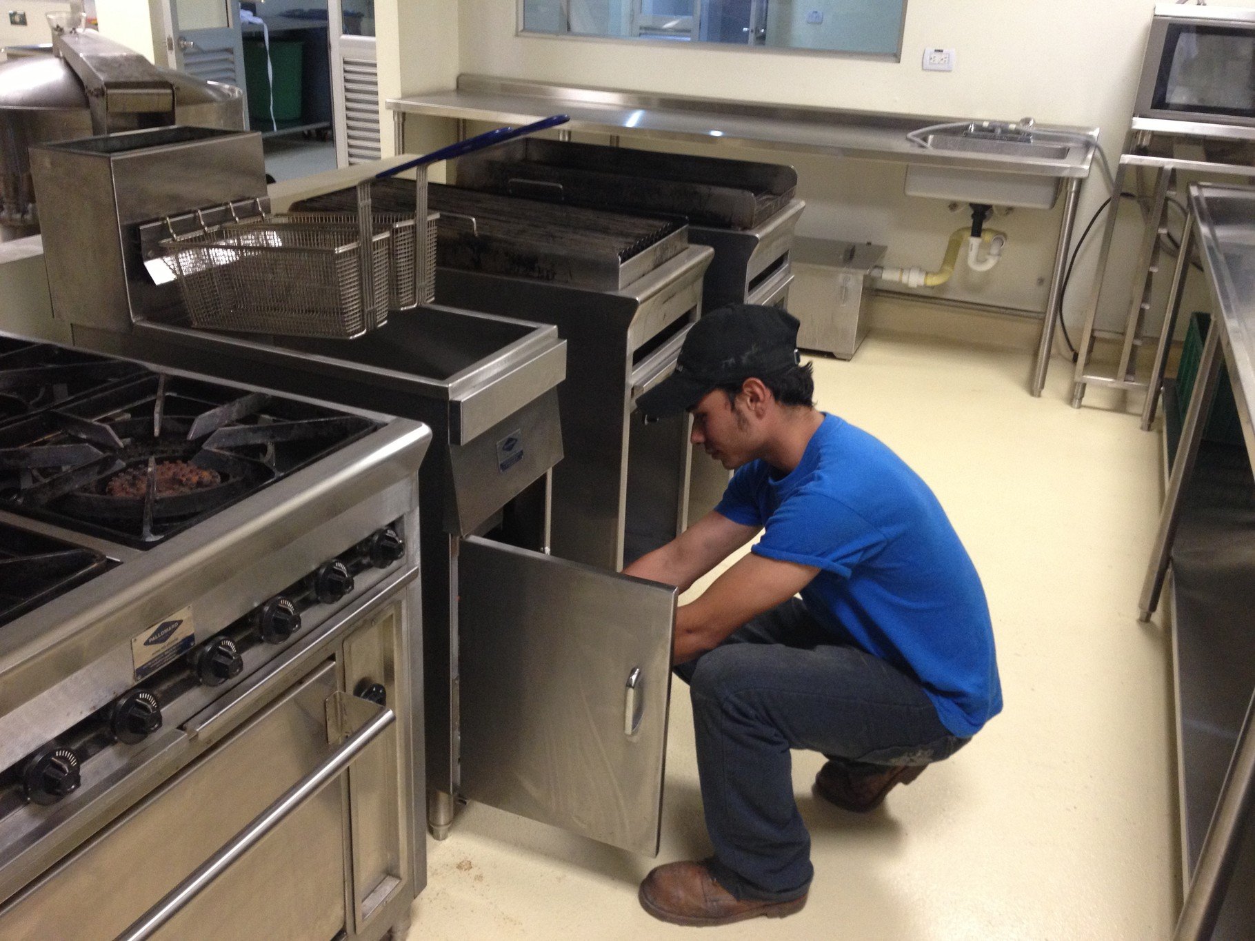 tecnico realizando mantenimiento a equipo de cocinas comerciales