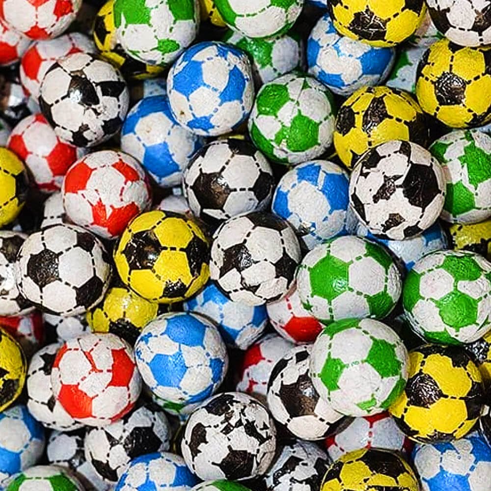 Loose chocolate footballs in hexagon pattern foil wrappers, multicoloured