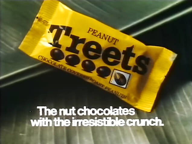 Peanut Treets advert featuring a yellow bag with brown text, with slogan "The nut chocolates with the irresistible crunch".