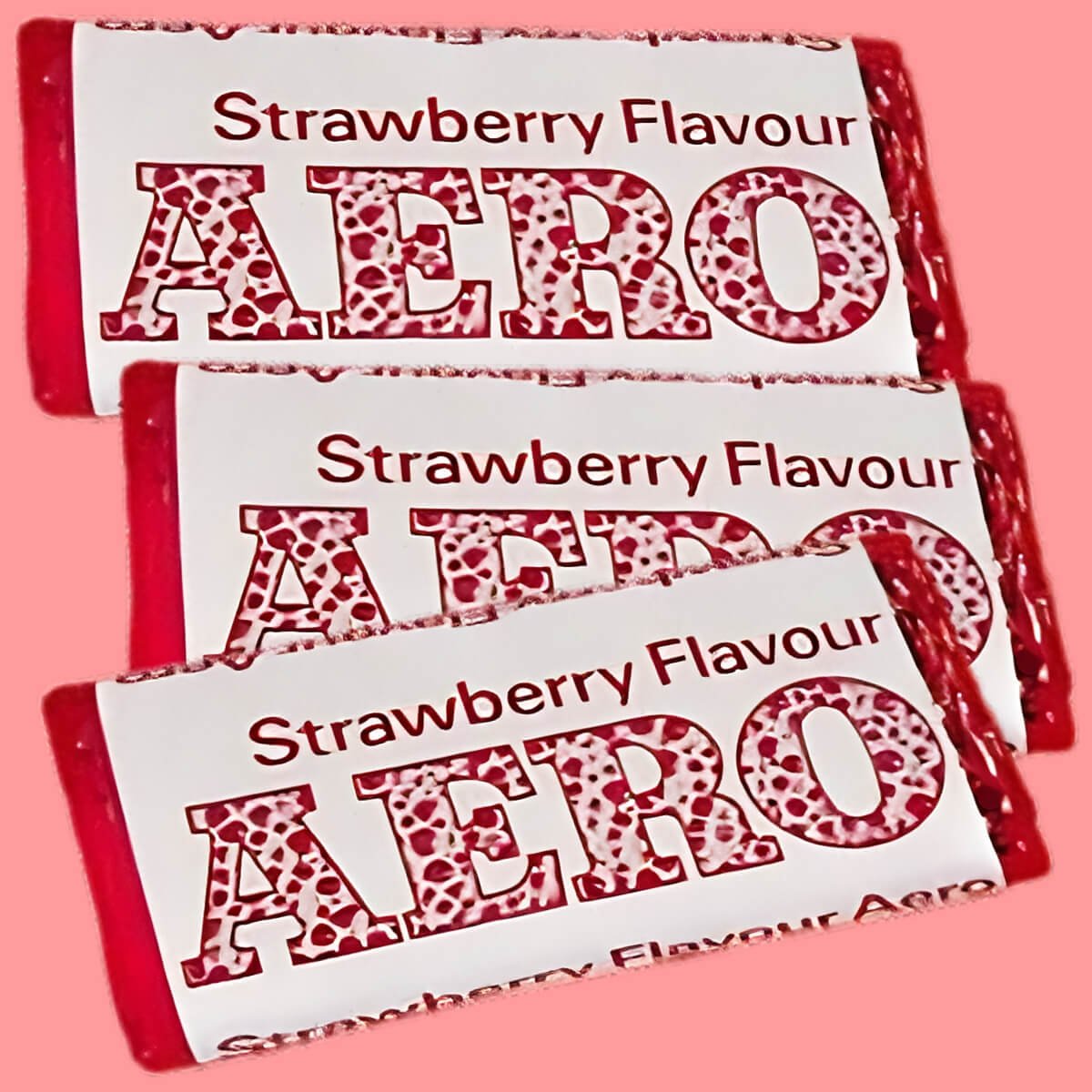 Three Strawberry Flavour Aero chocolate bars from 1970. Red and white wrappers with pink background