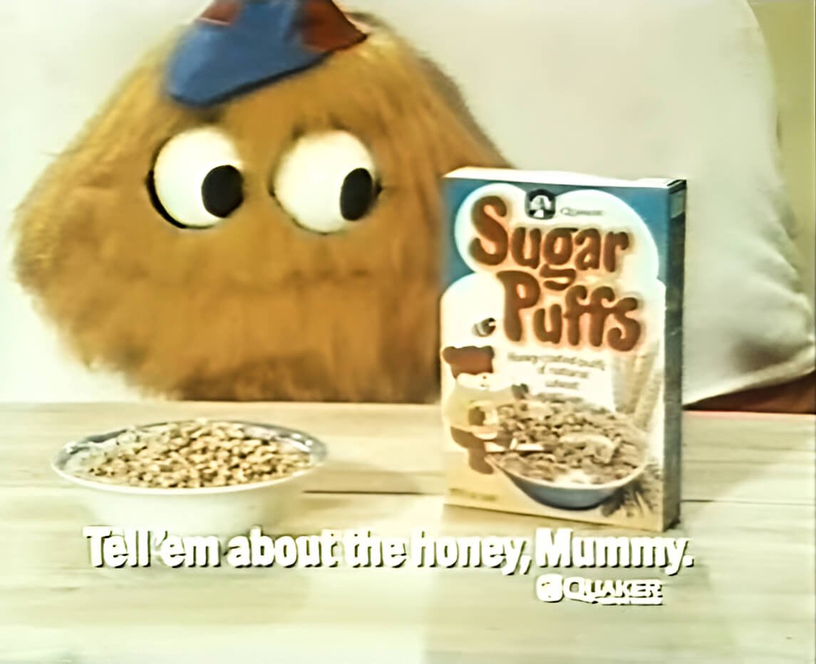Honey Monster looking at Sugar Puffs with slogan Tell em about the honey, Mummy.