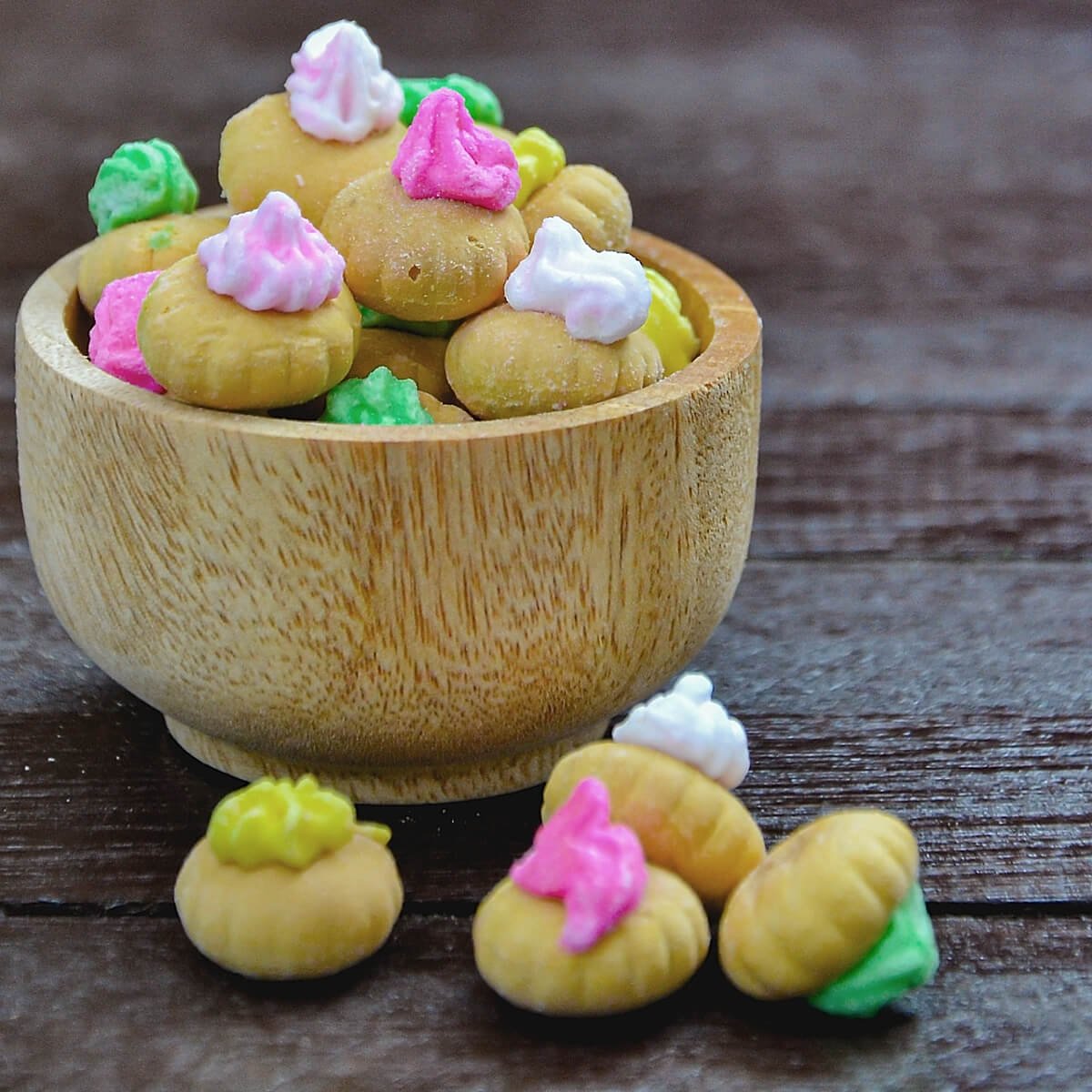 Wooden bowl filled with iced gems (mixed colours)