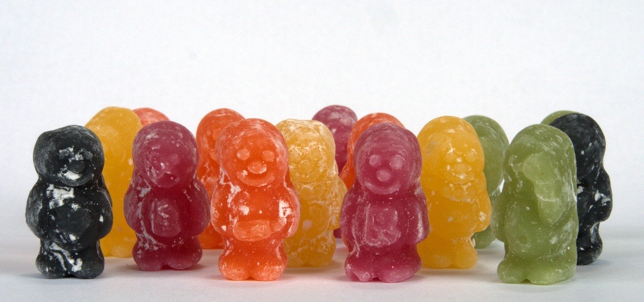 A group of different coloured Jelly Babies stood up.