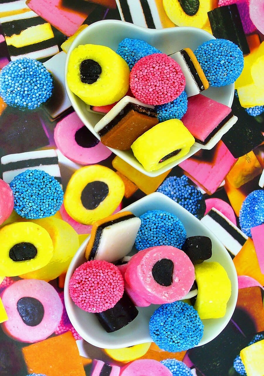 Close-up of Liquorice Allsorts, loose and in heart-shaped white dishes