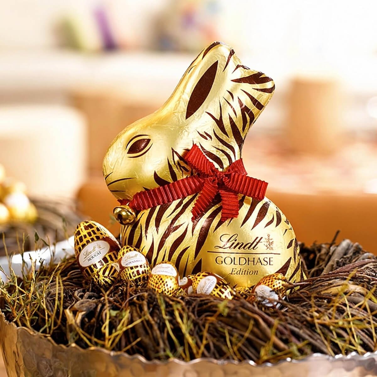 Lindt Gold Bunny with Tiger Print Gold Wrapper, in a nest with chocolate eggs