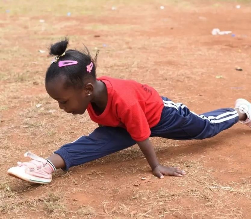 A young girl performing gymnastics